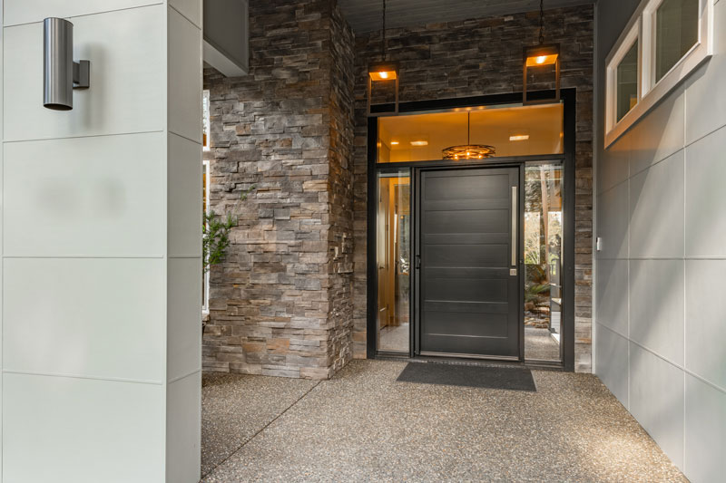 Large-black-wooden-front-door Large black wooden front door to a modern contemporary home.